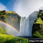 아이슬란드 영화 속 풍경 - **Prompt:** "A panoramic view of the Skógafoss waterfall in Iceland. The powerful cascade plummets d...